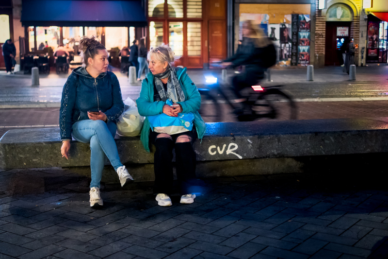 Two people speaking amidst passing movement by Jukka Heinovirta